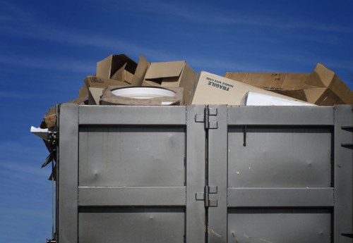 Operatives wearing PPE with a neatly placed skip ready for collection